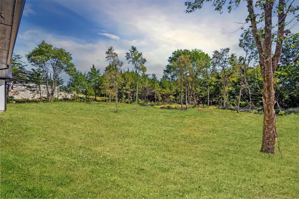 1418 Oak Hill Road Van Alstyne, TX 75495 - Photo 37 of 39 a view of a field with trees in the background