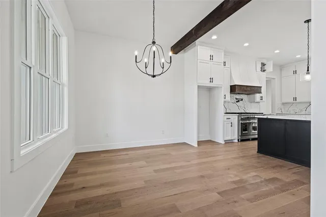 a view of kitchen with stainless steel appliances granite countertop cabinets and wooden floor