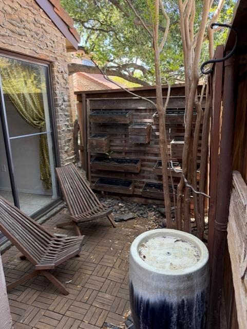 5626 Preston Oaks Road, Unit 4A Dallas, TX 75254 - Photo 13 of 15 a view of a chair and table in the backyard