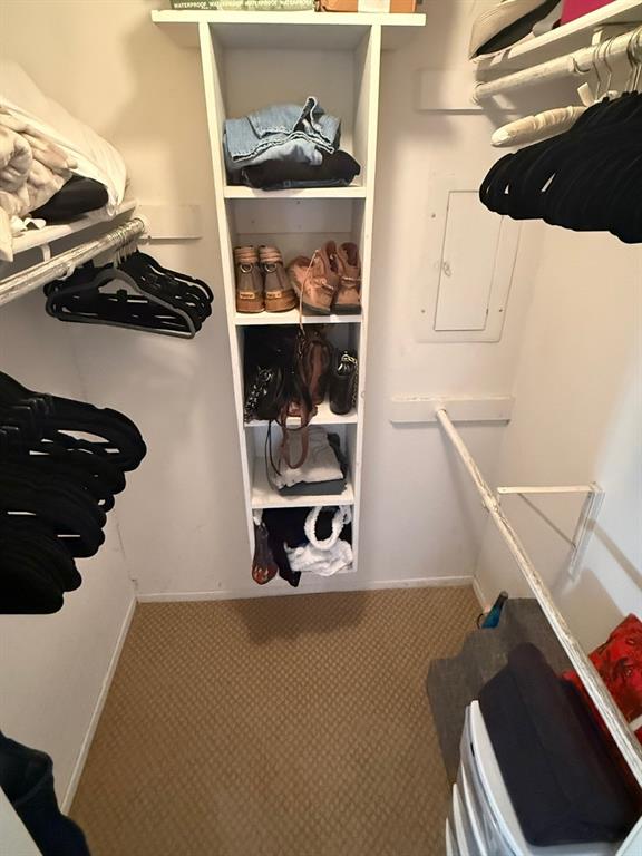 5626 Preston Oaks Road, Unit 4A Dallas, TX 75254 - Photo 14 of 15 a view of walk in closet with clothes and shoes
