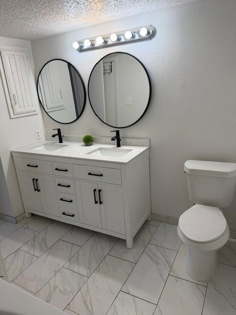 5626 Preston Oaks Road, Unit 4A Dallas, TX 75254 - Photo 6 of 15 a bathroom with a toilet mirror and sink