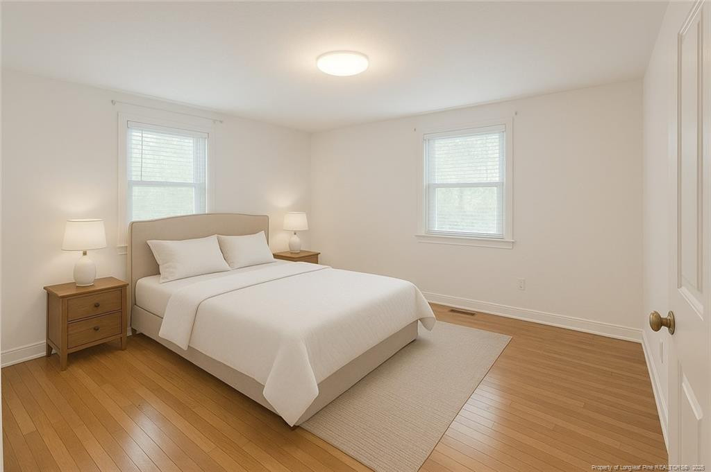 6566 Bend Of River Road Road Dunn, NC 28334 - Photo 12 of 20 a bedroom with a bed and a window