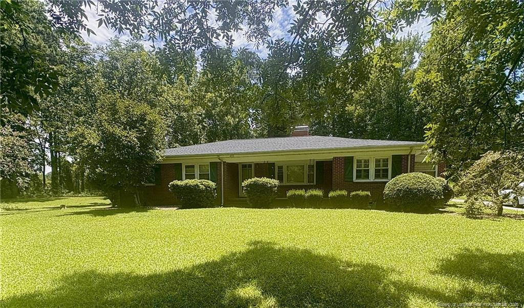 6566 Bend Of River Road Road Dunn, NC 28334 - Photo 16 of 20 a view of a house with a yard and sitting area