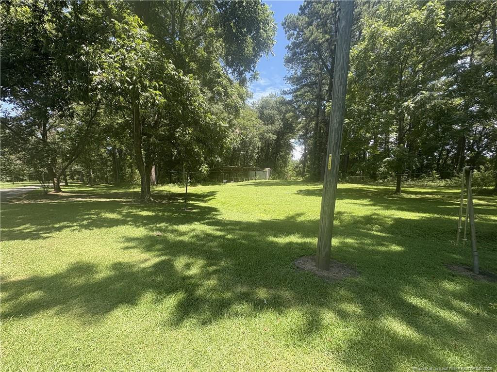 6566 Bend Of River Road Road Dunn, NC 28334 - Photo 18 of 20 a view of a park with trees in the background