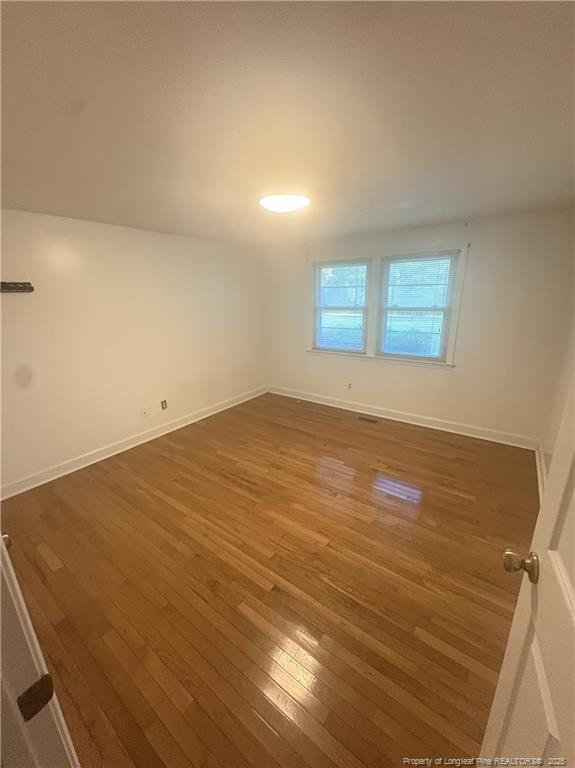 6566 Bend Of River Road Road Dunn, NC 28334 - Photo 7 of 20 an empty room with wooden floor and windows