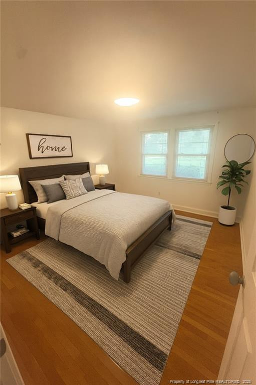 6566 Bend Of River Road Road Dunn, NC 28334 - Photo 8 of 20 a bedroom with a bed and a night stand