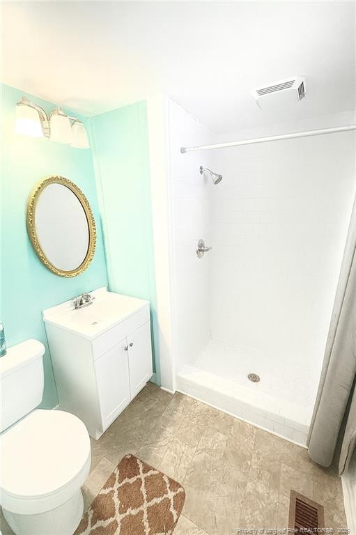 6566 Bend Of River Road Road Dunn, NC 28334 - Photo 10 of 20 a bathroom with a toilet sink vanity tub and mirror