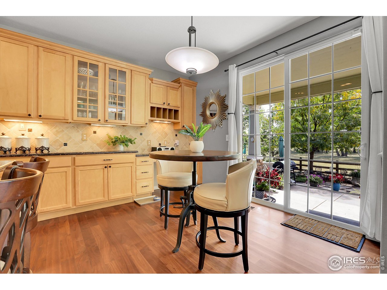 112 Austin Avenue Erie, CO 80516 - Photo 12 of 44 a kitchen with sink a window and chairs