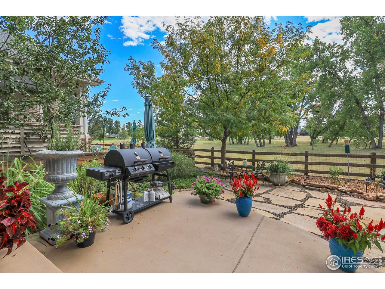 112 Austin Avenue Erie, CO 80516 - Photo 19 of 44 a view of a patio with table and chairs and potted plants