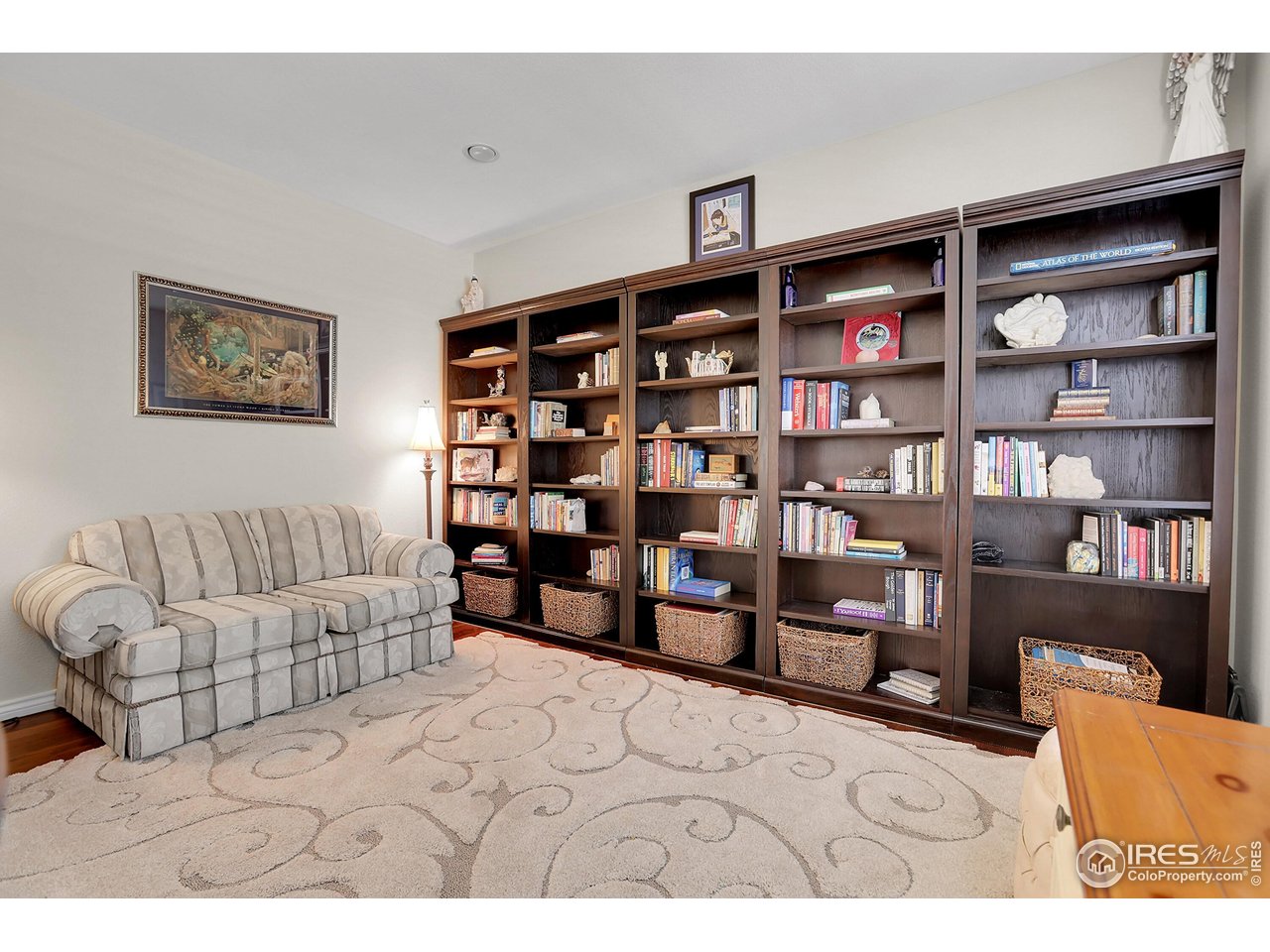 112 Austin Avenue Erie, CO 80516 - Photo 21 of 44 a living room with furniture cabinets and book shelf