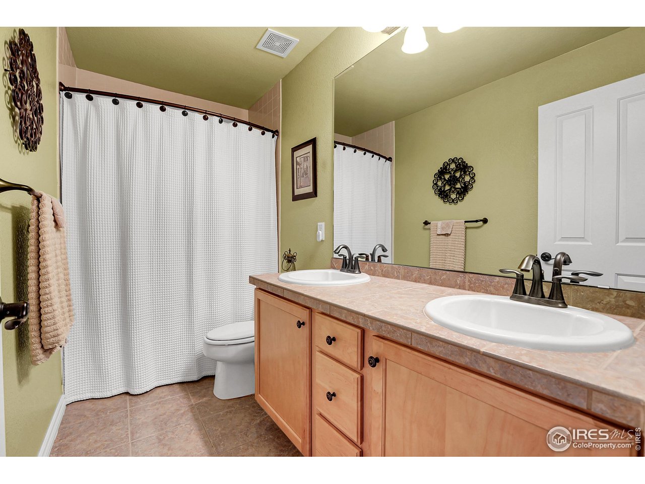 112 Austin Avenue Erie, CO 80516 - Photo 34 of 44 a bathroom with a double vanity sink mirror and toilet