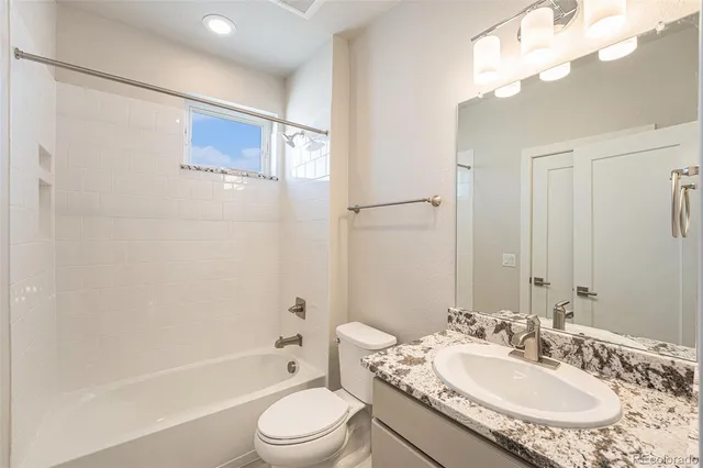 an empty room with closet and a bathroom