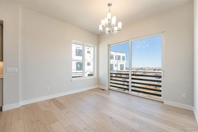 a view of a room with wooden floors and chandelier
