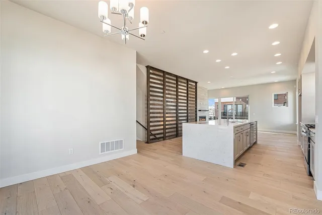 an empty room with wooden floor and a fireplace
