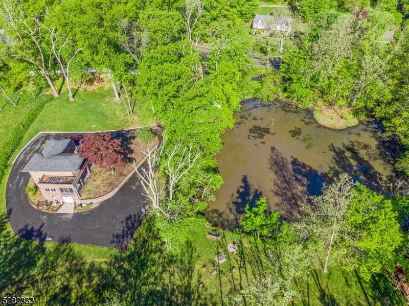 242 Lake Road Morristown, NJ 07960 - Photo 11 of 47 an aerial view of a house with a yard and a fountain