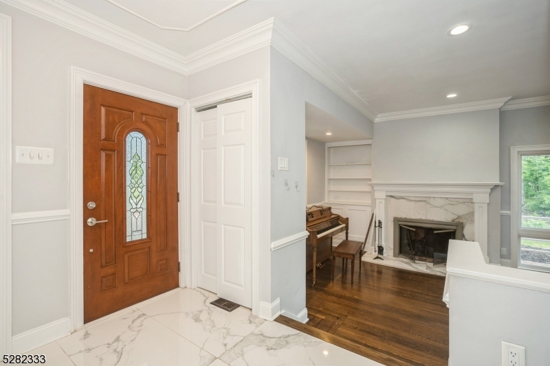 242 Lake Road Morristown, NJ 07960 - Photo 18 of 47 a living room with a fireplace and a wooden floor