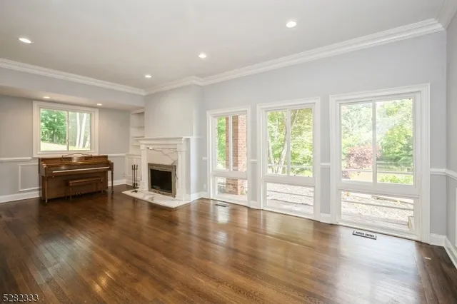 a kitchen with white cabinets appliances a sink and a window