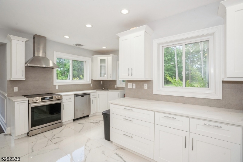 242 Lake Road Morristown, NJ 07960 - Photo 26 of 47 a kitchen with white cabinets appliances a sink and a window