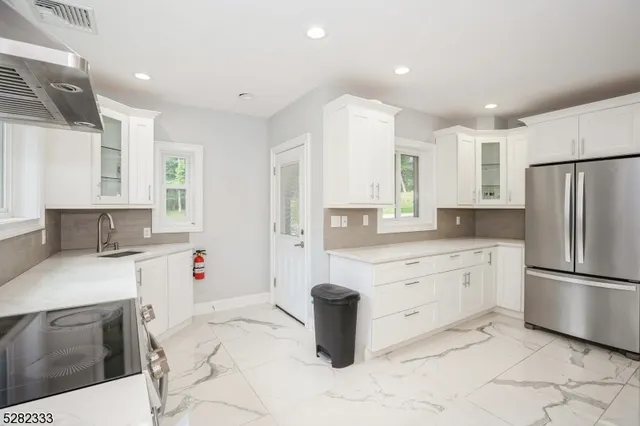 a kitchen with a sink stove and cabinets