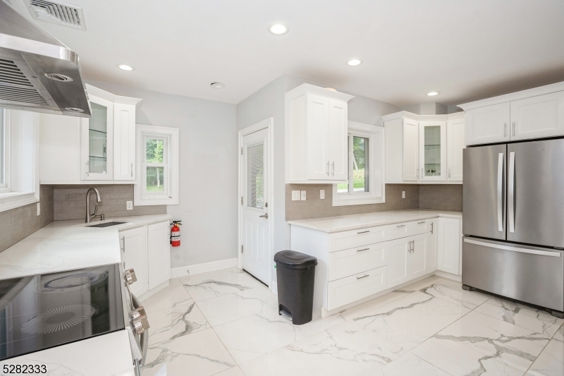 242 Lake Road Morristown, NJ 07960 - Photo 27 of 47 a kitchen with granite countertop a sink stove and refrigerator