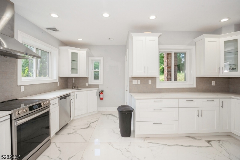 242 Lake Road Morristown, NJ 07960 - Photo 28 of 47 a kitchen with a sink stove and cabinets