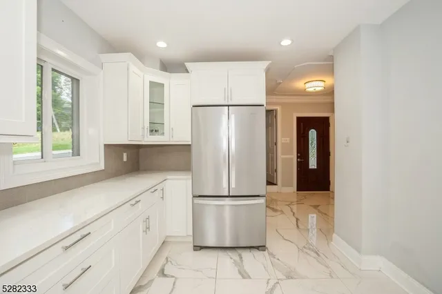 a kitchen with a stove cabinets and a window