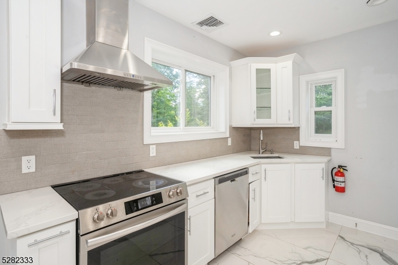 242 Lake Road Morristown, NJ 07960 - Photo 30 of 47 a kitchen with a stove cabinets and a window