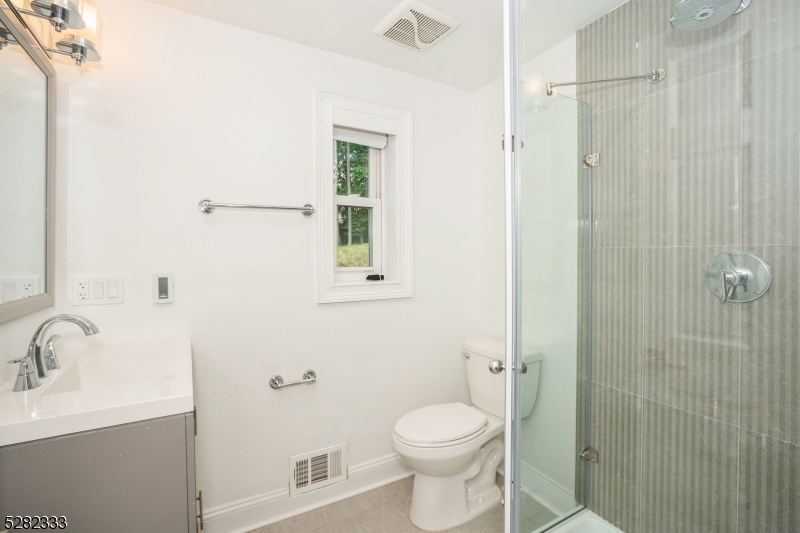 242 Lake Road Morristown, NJ 07960 - Photo 34 of 47 a bathroom with a toilet a sink and shower