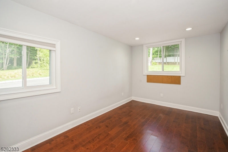 242 Lake Road Morristown, NJ 07960 - Photo 40 of 47 an empty room with wooden floor and windows