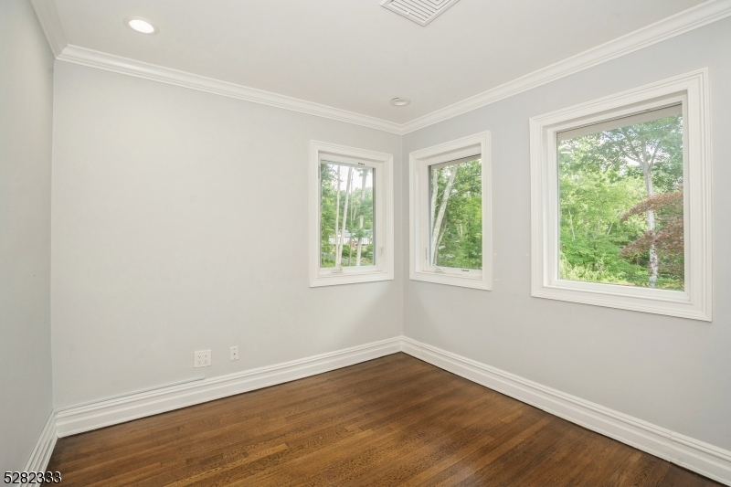 242 Lake Road Morristown, NJ 07960 - Photo 42 of 47 a view of an empty room with wooden floor and a window