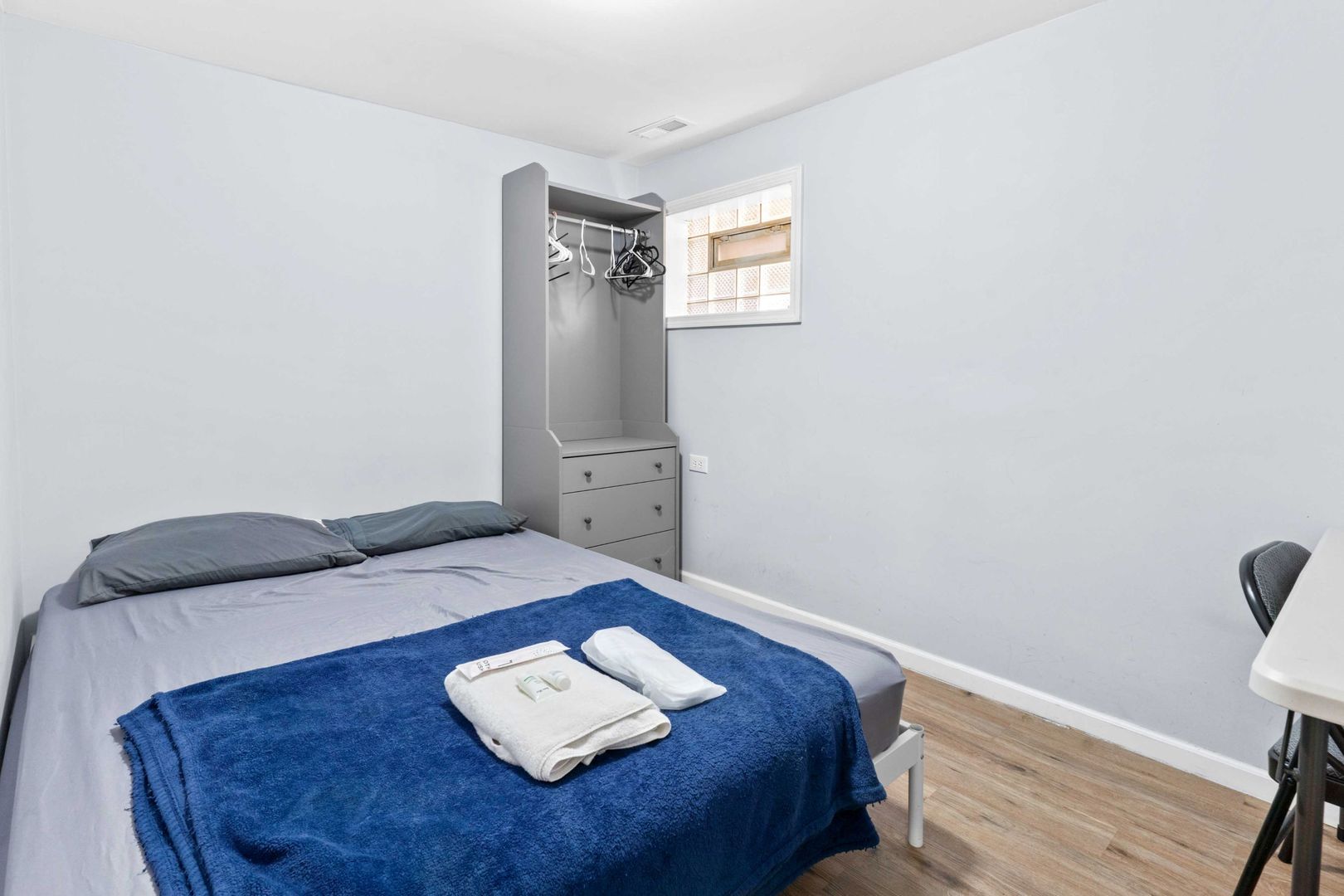 1835 West 34th Street Chicago, IL 60608 - Photo 17 of 22 a bed sitting in a bedroom next to a window with wooden floor
