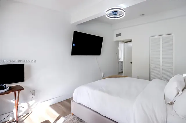 a bedroom with a flat screen tv and a wall