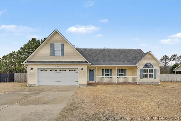 a view of a house with a yard and garage