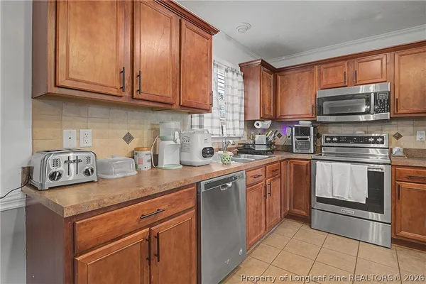 a kitchen with stainless steel appliances granite countertop a sink stove microwave and cabinets