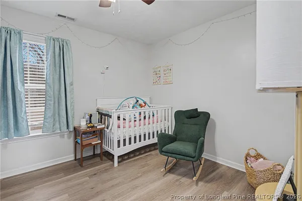 a bedroom with a bed and a chair
