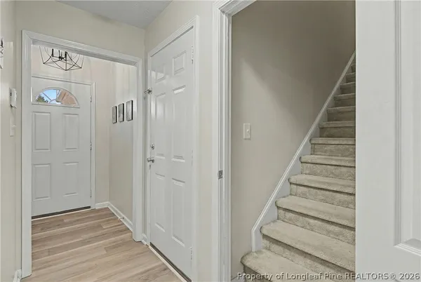 a view of a hallway with wooden floor and entryway