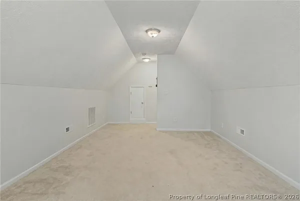 an empty room with an entrance to other room