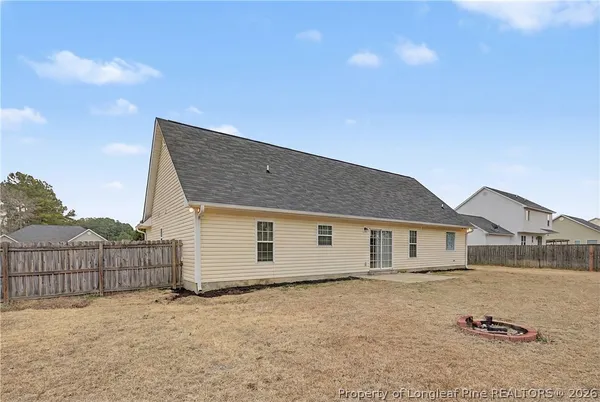 a view of a house with a wooden fence