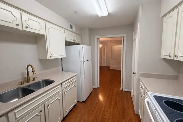 a kitchen with a refrigerator and a sink