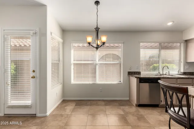 a kitchen with kitchen island granite countertop a stove a sink a dining table and chairs with wooden floor