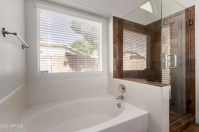 a white bath tub sitting next to a window