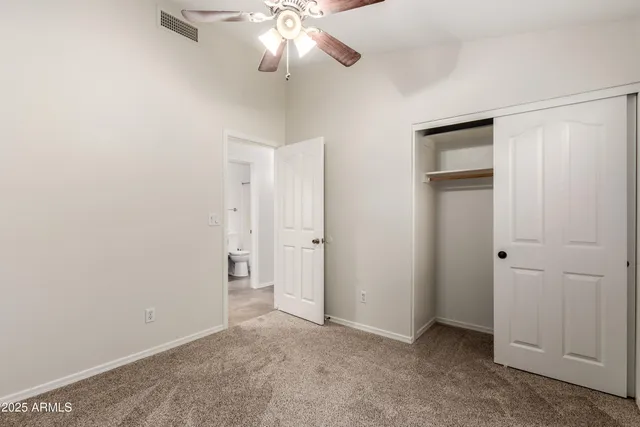 an empty room with a empty space and a ceiling fan