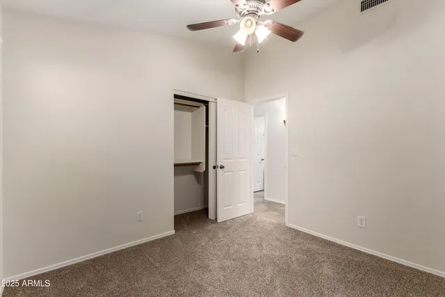 an empty room with a empty space and a ceiling fan