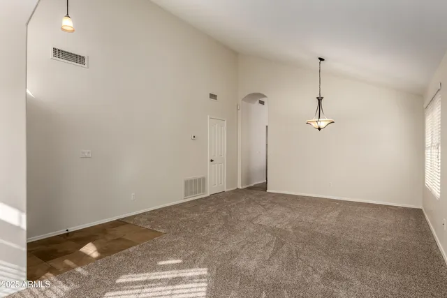 a view of empty room with ceiling fan