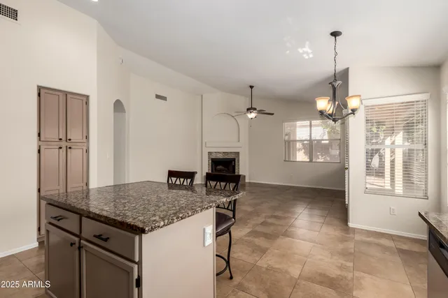 a kitchen with kitchen island a counter top space appliances and a center island