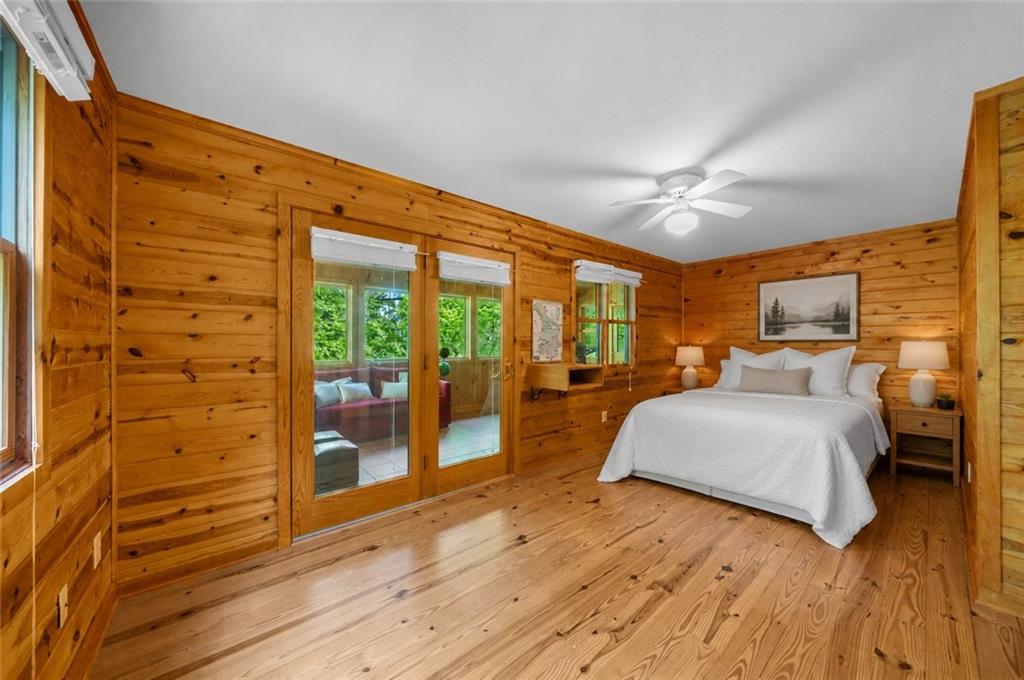 470 Sautee Ridge Road Clarkesville, GA 30523 - Photo 13 of 37 a spacious bedroom with a large bed and a chandelier
