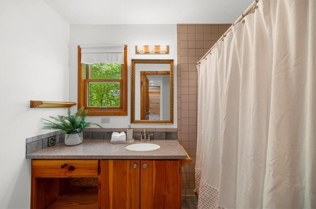 470 Sautee Ridge Road Clarkesville, GA 30523 - Photo 14 of 37 a bathroom with a sink a mirror and a window