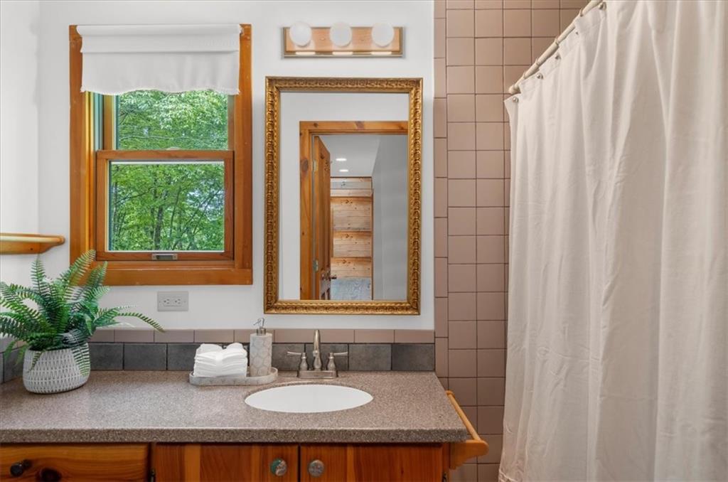 470 Sautee Ridge Road Clarkesville, GA 30523 - Photo 15 of 37 a bathroom with a sink a mirror and a window