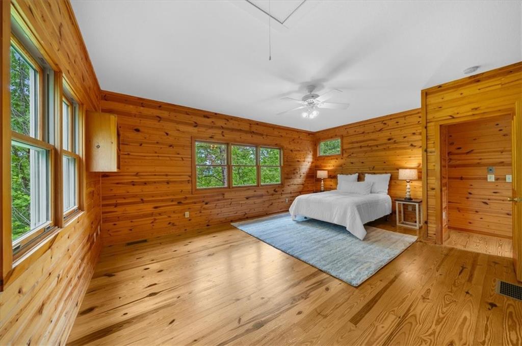 470 Sautee Ridge Road Clarkesville, GA 30523 - Photo 17 of 37 a bedroom with a bed and wooden floor
