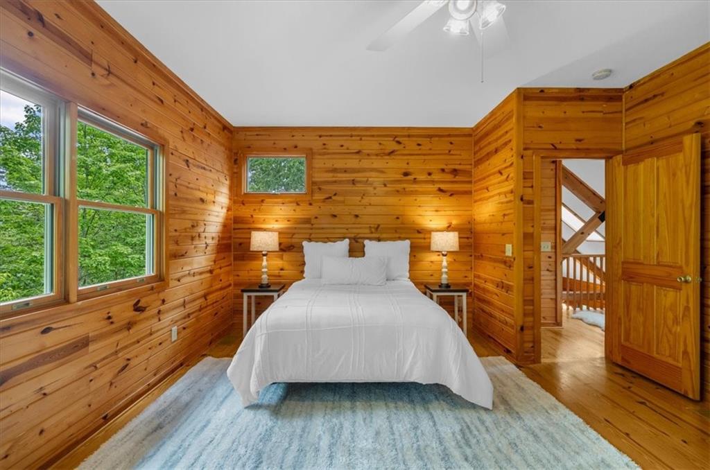 470 Sautee Ridge Road Clarkesville, GA 30523 - Photo 18 of 37 a bedroom with a bed and wooden floor